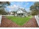 Charming home featuring a manicured front yard with a white picket fence and lush landscaping at 415 W Rich Ave, Deland, FL 32720