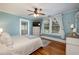 Main bedroom features hardwood floors, a ceiling fan, and a large window at 415 W Rich Ave, Deland, FL 32720