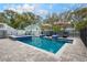 Relaxing backyard oasis with a sparkling blue pool, sun loungers, and lush landscaping at 415 W Rich Ave, Deland, FL 32720