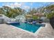 Backyard pool with stone patio, lounge chairs, and surrounding trees at 415 W Rich Ave, Deland, FL 32720