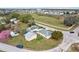 Aerial view of a residential property featuring multiple structures on a grassy lot with street access at 4431 Clubhouse Rd, Lakeland, FL 33812