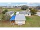 View of a home with a detached garage with carport and well-maintained lawn at 4431 Clubhouse Rd, Lakeland, FL 33812