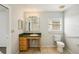 Neutral bathroom featuring a vanity with a green countertop, window, toilet, and tiled flooring at 4431 Clubhouse Rd, Lakeland, FL 33812