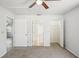 Neutral bedroom featuring a ceiling fan, carpet and three doors or closets at 4431 Clubhouse Rd, Lakeland, FL 33812