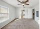 Bright bedroom featuring neutral carpet, a ceiling fan, and lots of natural light at 4431 Clubhouse Rd, Lakeland, FL 33812