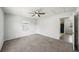 Neutral bedroom featuring a ceiling fan, a window with natural light and carpet at 4431 Clubhouse Rd, Lakeland, FL 33812