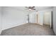 Neutral bedroom featuring a ceiling fan, carpet and three doors or closets at 4431 Clubhouse Rd, Lakeland, FL 33812