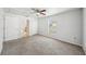 Neutral bedroom featuring a ceiling fan, carpet and a window with natural light at 4431 Clubhouse Rd, Lakeland, FL 33812