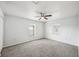 Neutral bedroom featuring two windows with natural light, a ceiling fan and carpet at 4431 Clubhouse Rd, Lakeland, FL 33812