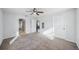 Spacious bedroom with neutral carpet, ceiling fan, and ample natural light streaming through large window at 4431 Clubhouse Rd, Lakeland, FL 33812