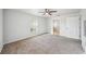 Light-filled bedroom features neutral carpet, a ceiling fan, and offers views of the en suite bathroom at 4431 Clubhouse Rd, Lakeland, FL 33812