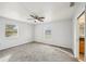 Neutral bedroom featuring two windows with natural light, a ceiling fan and carpet at 4431 Clubhouse Rd, Lakeland, FL 33812