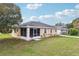 Charming exterior view of a single-story home with white trim, a screened entrance, and a well-maintained lawn at 4431 Clubhouse Rd, Lakeland, FL 33812