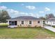 Charming exterior view of a single-story home with white trim, a screened entrance, and a well-maintained lawn at 4431 Clubhouse Rd, Lakeland, FL 33812