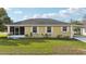 Charming exterior view of a single-story home with white trim, a screened entrance, and a well-maintained lawn at 4431 Clubhouse Rd, Lakeland, FL 33812