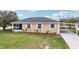 Charming exterior view of a single-story home with white trim, a screened entrance, and a well-maintained lawn at 4431 Clubhouse Rd, Lakeland, FL 33812