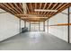 Spacious garage with exposed wooden beams, white walls, and painted gray flooring at 4431 Clubhouse Rd, Lakeland, FL 33812