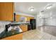 Kitchen featuring wood cabinets, black appliances, and seamless transition to living room at 4431 Clubhouse Rd, Lakeland, FL 33812