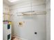 Bright laundry area with tiled floor, water heater, and convenient washer and dryer hookups at 4431 Clubhouse Rd, Lakeland, FL 33812