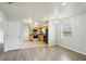 View of the living room and kitchen featuring laminate floors, modern appliances, and neutral color palette at 4431 Clubhouse Rd, Lakeland, FL 33812