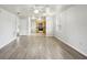 Open-concept living room with gray laminate flooring, ceiling fan, and views into the kitchen with modern appliances at 4431 Clubhouse Rd, Lakeland, FL 33812