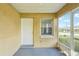 Enclosed porch showcasing the entrance, adorned with a storm door, and featuring a bright and airy design at 4431 Clubhouse Rd, Lakeland, FL 33812