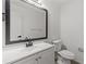 Elegant bathroom features a vanity with a large mirror and updated fixtures and toilet at 4940 Spring Run Ave, Orlando, FL 32819