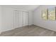 Well-lit room with a large window for light, a sizable closet, and light wood flooring at 4940 Spring Run Ave, Orlando, FL 32819