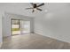 Minimalist bedroom features wood floors, a ceiling fan, and a sliding glass door for easy access to the patio at 4940 Spring Run Ave, Orlando, FL 32819