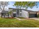 Contemporary two-story house boasts mature trees, fresh landscaping, and an attached two-car garage at 4940 Spring Run Ave, Orlando, FL 32819