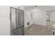 Corner of kitchen with stainless steel refrigerator, cabinets, and a view into the dining area at 4940 Spring Run Ave, Orlando, FL 32819