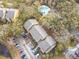 Aerial view of the apartment building with a pool and parking lot surrounded by trees at 5255 Images Cir # 305, Kissimmee, FL 34746