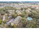 Aerial view of the apartment community with a pool, ponds, and wooded areas at 5255 Images Cir # 305, Kissimmee, FL 34746