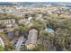 Aerial view of the apartment community with a pool, ponds, and wooded areas at 5255 Images Cir # 305, Kissimmee, FL 34746