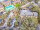 Aerial view showcasing tennis courts, verdant landscaping, parking areas, and attractive buildings at 5255 Images Cir # 305, Kissimmee, FL 34746