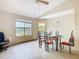 Well-lit dining area with tile flooring, ceiling fan, and a glass-top table, perfect for entertaining at 5255 Images Cir # 305, Kissimmee, FL 34746