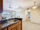 Bright kitchen featuring wood cabinets and a stainless steel sink, seamlessly connected to the dining area at 5255 Images Cir # 305, Kissimmee, FL 34746