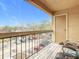 Balcony overlooking the parking area and features a wooden deck and chairs at 5255 Images Cir # 305, Kissimmee, FL 34746