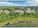 Stunning aerial view of a community surrounded by lush greenery and a serene lake at 584 Brantley Terrace Way # 209, Altamonte Springs, FL 32714