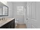 Neutral bathroom featuring a vanity with black cabinets, framed mirror, and a window for natural lighting at 584 Brantley Terrace Way # 209, Altamonte Springs, FL 32714