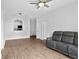 Open living area featuring wood-look floors and a comfortable gray sofa at 584 Brantley Terrace Way # 209, Altamonte Springs, FL 32714