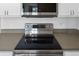 Close-up of a stainless steel electric LG stove top with black glass cooktop at 584 Brantley Terrace Way # 209, Altamonte Springs, FL 32714