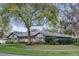 Inviting single-story home with mature trees, lush landscaping and metal roof at 7545 Lake Dr, Belle Isle, FL 32809