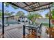 The outdoor dining area features a modern pergola, seating, and a view of the pool at 7545 Lake Dr, Belle Isle, FL 32809