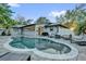 Backyard with a kidney-shaped pool, white fence, and outdoor furniture at 7545 Lake Dr, Belle Isle, FL 32809