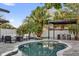 Inviting pool area features modern furniture, pergola, and well-manicured landscaping at 7545 Lake Dr, Belle Isle, FL 32809