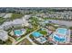 Aerial view of resort with a community pool, colorful homes, and lush landscaping at 8146 Coconut Pl, Kissimmee, FL 34747