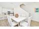 Bright dining area with a white table, six chairs, and easy access to the kitchen and living spaces at 8146 Coconut Pl, Kissimmee, FL 34747