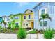 Colorful townhome exteriors with tropical landscaping along a sidewalk at 8146 Coconut Pl, Kissimmee, FL 34747