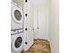 Laundry room featuring a stacked washer and dryer and dark hardware at 8146 Coconut Pl, Kissimmee, FL 34747